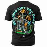 A black short-sleeve t-shirt shown from the back, featuring a large graphic print of a skull construction worker in an orange hard hat with the text 'BUILDING SHIT YOU CAN'T' in light blue arched above.