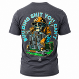 An heather navy t-shirt shown from the back, featuring a large graphic of a skeleton construction worker wearing a hard hat and holding a wrench, with stacks of money and a city skyline. The text 'BUILDING SHIT YOU CAN'T' is printed in light blue around the graphic.