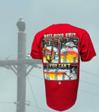 A graphic t-shirt with a design depicting a lineman working on a power line, with elements of electricity pylons, a helicopter, and a sunset or sunrise in the background. The text on the shirt reads 'BUILDING SHIT YOU CAN'T'.